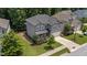 Aerial view showcases a two-story home with a well-manicured front lawn, landscaping, and gray exterior at 516 Culmore Dr, Fuquay Varina, NC 27526
