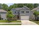 Charming two-story home features a manicured lawn, gray siding and a welcoming front porch at 516 Culmore Dr, Fuquay Varina, NC 27526