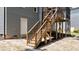 View of the wood staircase in the home's backyard leading to screened-in porch at 516 Culmore Dr, Fuquay Varina, NC 27526
