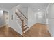 Bright foyer boasts wood floors, white trim, and a staircase leading to the second floor at 516 Culmore Dr, Fuquay Varina, NC 27526