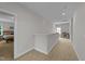 Bright hallway with carpet flooring leading to a bedroom and a sitting area at 516 Culmore Dr, Fuquay Varina, NC 27526