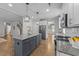 Well-appointed kitchen featuring an island, granite countertops, stainless steel appliances, and wood floors at 516 Culmore Dr, Fuquay Varina, NC 27526