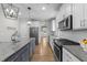 Modern kitchen with stainless steel appliances, granite countertops, and a stylish island at 516 Culmore Dr, Fuquay Varina, NC 27526
