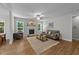 Bright living room with a decorative fireplace, hardwood floors, natural light and comfortable seating at 516 Culmore Dr, Fuquay Varina, NC 27526