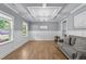 Airy living room with wood floors, wainscotting, a coffered ceiling, and plenty of natural light at 516 Culmore Dr, Fuquay Varina, NC 27526