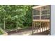 Inviting screened-in porch offers a relaxing outdoor space with a ceiling fan and view of the trees at 516 Culmore Dr, Fuquay Varina, NC 27526