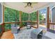 Relaxing screened porch featuring wood flooring and trim, ceiling fan, and view of the wooded lot at 516 Culmore Dr, Fuquay Varina, NC 27526