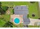 Overhead view featuring a rectangular home with an in-ground pool, outdoor firepit, and a well-manicured yard at 5405 Overdale Ln, Raleigh, NC 27603