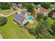 Aerial view showcasing a home with an in-ground pool, firepit, charming front porch, and beautifully landscaped grounds at 5405 Overdale Ln, Raleigh, NC 27603