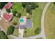 Aerial view of a home's in-ground pool, outdoor fire pit and surrounding lush landscape at 5405 Overdale Ln, Raleigh, NC 27603