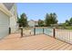 Wood deck overlooking the backyard pool in a backyard with green grass and tall trees at 5405 Overdale Ln, Raleigh, NC 27603