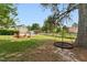 Spacious backyard featuring a pool, fire pit and tree swing with a clear blue sky at 5405 Overdale Ln, Raleigh, NC 27603