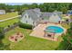 Lovely backyard with an in-ground pool, outdoor firepit, and a wooden deck on a two-story home at 5405 Overdale Ln, Raleigh, NC 27603