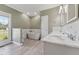 Bright bathroom featuring a soaking tub, marble countertops, and wood-look tile flooring at 5405 Overdale Ln, Raleigh, NC 27603
