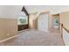 Loft style bedroom with large arched window, neutral carpet, and spacious closet at 5405 Overdale Ln, Raleigh, NC 27603