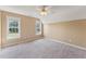 Comfortable bedroom with neutral carpet, dual windows, and ceiling fan at 5405 Overdale Ln, Raleigh, NC 27603