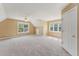 Spacious bonus room with neutral carpet, ceiling fan, and plenty of natural light at 5405 Overdale Ln, Raleigh, NC 27603