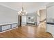 Bright dining room featuring hardwood floors, neutral paint, and elegant chandelier at 5405 Overdale Ln, Raleigh, NC 27603