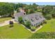 Expansive home featuring a welcoming front porch, three dormers, attached garage, and a lush landscaped yard at 5405 Overdale Ln, Raleigh, NC 27603