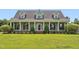 Inviting traditional home with a spacious front porch, white columns, and meticulously manicured lawn at 5405 Overdale Ln, Raleigh, NC 27603