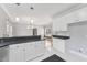 Open kitchen with white cabinetry, granite countertops, and stainless steel appliances at 5405 Overdale Ln, Raleigh, NC 27603