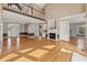 Spacious living room featuring hardwood floors, a fireplace with built-ins, and a second-story overlook at 5405 Overdale Ln, Raleigh, NC 27603