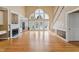 Bright living room with large windows, hardwood floors, fireplace, and staircase at 5405 Overdale Ln, Raleigh, NC 27603
