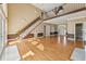 Open-concept living room with hardwood floors, a fireplace, and staircase to the second story at 5405 Overdale Ln, Raleigh, NC 27603