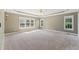 Spacious primary bedroom with tray ceiling, plush carpeting, and abundant natural light at 5405 Overdale Ln, Raleigh, NC 27603