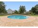 In-ground pool with surrounding brick patio in a yard with a privacy fence and mature trees at 5405 Overdale Ln, Raleigh, NC 27603