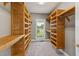 Spacious walk-in closet with custom shelving and natural light from a window at 5405 Overdale Ln, Raleigh, NC 27603