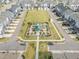 Aerial view of neighborhood garden, park, and surrounding townhomes at 5908 Giddings St, Raleigh, NC 27616