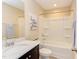 Bright bathroom boasts a white vanity with a dark cabinet and a shower-tub combo at 5908 Giddings St, Raleigh, NC 27616