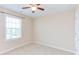 Neutral bedroom features a ceiling fan, window with blinds, and carpeted floors at 5908 Giddings St, Raleigh, NC 27616