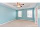 Light-filled bedroom with tray ceilings, carpet floors and dual windows at 5908 Giddings St, Raleigh, NC 27616