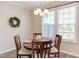 Bright dining area with modern chandelier, wooden table and chairs, and large windows at 5908 Giddings St, Raleigh, NC 27616