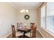 Dining room with wooden table, chair, natural lighting, and decorative wreath, perfect for Gathering gatherings at 5908 Giddings St, Raleigh, NC 27616