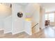 Bright entryway with wood floors, staircase, and stylish round mirror detail at 5908 Giddings St, Raleigh, NC 27616