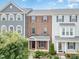 Brick townhome boasting colorful shutters, well-kept landscaping, and a welcoming front porch at 5908 Giddings St, Raleigh, NC 27616