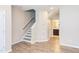 Inviting foyer featuring staircase, beautiful wood-look flooring, and recessed lighting at 5908 Giddings St, Raleigh, NC 27616