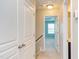 Bright hallway with white doors, neutral walls, and a view into a blue-walled bedroom at 5908 Giddings St, Raleigh, NC 27616
