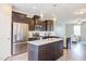 Spacious kitchen with dark wood cabinets, granite island, and stainless steel appliances at 5908 Giddings St, Raleigh, NC 27616