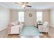 Cozy living room boasts a ceiling fan, neutral tones, and a soft area rug over hardwood floors at 5908 Giddings St, Raleigh, NC 27616