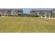 Community green space with grass and residences in the background at 5908 Giddings St, Raleigh, NC 27616