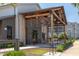 Exterior building featuring an outdoor patio, and overhead covering, surrounded by green landscaping at 5908 Giddings St, Raleigh, NC 27616