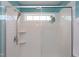 Modern tiled shower featuring a window, shelving and rainfall shower head at 5908 Giddings St, Raleigh, NC 27616