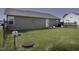 Exterior of home showcasing a well-maintained backyard with a small patio and green grass at 60 Falling Leaf Ln, Benson, NC 27504