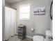 Clean bathroom with a shower-tub combination, rustic decor, and storage shelves for an organized space at 60 Falling Leaf Ln, Benson, NC 27504