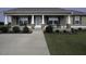 Charming home featuring a covered front porch with inviting rocking chairs and beautifully landscaped front yard at 60 Falling Leaf Ln, Benson, NC 27504