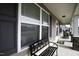 Welcoming front porch adorned with stylish bench and rocking chairs, perfect for relaxation and enjoying outdoors at 60 Falling Leaf Ln, Benson, NC 27504